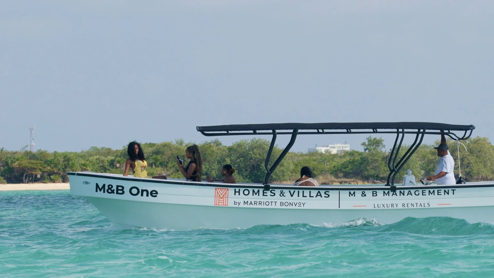 M&B Luxury Rentals exclusive boat shuttle featuring Marriott Bonvoy branding for guest transfers in Mahogany Bay.